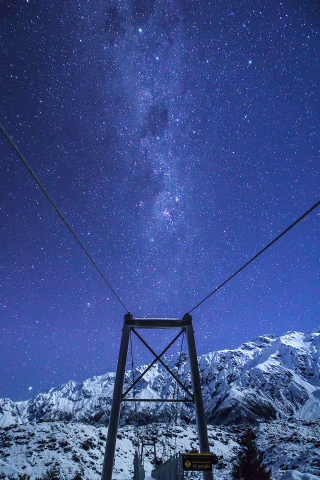 Milky Way over a swing bridge
