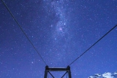 Milky Way over a swing bridge