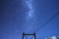 Milky Way over a swing bridge
